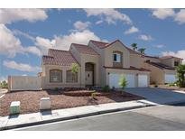 Attractive two-story home with a red tile roof, low maintenance desert landscaping, and a two-car garage at 426 Lost Trail Dr, Henderson, NV 89014