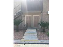 Condo entrance with two front doors, steps leading up, and desert landscaping with pebble ground covering at 5000 Indian River Dr # 483, Las Vegas, NV 89103