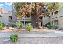 Charming condo complex featuring desert landscaping, multiple stories, and architectural details at 5042 S Rainbow Blvd # 206, Las Vegas, NV 89118