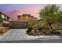 Charming two-story home featuring a terracotta roof, well-manicured landscaping, and an attached two-car garage at 5568 Table Top Ln, Las Vegas, NV 89135