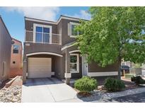 Charming two-story home with a quaint balcony, attached garage and well-manicured front yard at 6313 Pangea Ave, Las Vegas, NV 89139
