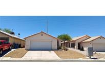 Charming single-story home with a well-maintained front yard and attached two-car garage at 6615 Elk Creek Ln, Las Vegas, NV 89156