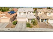 Inviting two-story home featuring a well-maintained front yard and a two car garage with desert landscaping at 7032 Wonderberry St, Las Vegas, NV 89131