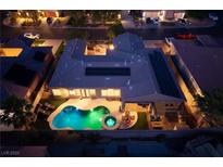 Stunning aerial view of a backyard featuring a pool and jacuzzi, complemented by solar panels at 8149 Villa De La Playa St, Las Vegas, NV 89131