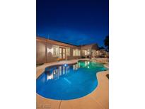 Inviting backyard pool with lush landscaping and patio area, perfect for outdoor entertaining and relaxation at 8149 Villa De La Playa St, Las Vegas, NV 89131