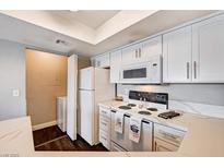 Well-lit kitchen with white cabinets, stainless steel appliances, and a laundry area at 8600 W Charleston Blvd # 1059, Las Vegas, NV 89117