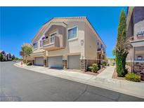 Inviting multi-story townhome with a private balcony, attached garage, and neat landscaping at 8768 Tom Noon Ave # 101, Las Vegas, NV 89178