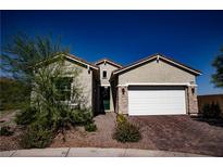 Charming single-story home with desert landscaping, paver driveway, and attached two-car garage at 879 Klamath Springs St, Henderson, NV 89011
