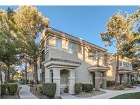 Inviting condo featuring neutral stucco, red tile roof, decorative columns and lush landscaping at 9050 Warm Springs Rd # 2050, Las Vegas, NV 89148