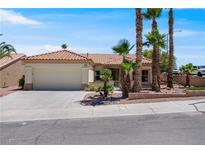 Charming single-story home with well-maintained landscaping and a two-car garage at 11009 Summers End Ave, Las Vegas, NV 89134