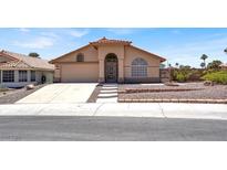 Charming single-story home with a well-manicured front yard and a covered entryway at 1613 Glenrosa Dr, North Las Vegas, NV 89031