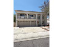 Two-story home with three-car garage, balcony, and well-maintained front yard at 1941 Golden Trumpet Ave, Las Vegas, NV 89123
