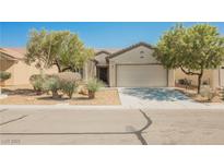 Charming single-story home with desert landscaping, neutral paint, and a two-car garage at 3405 Kingbird Dr, North Las Vegas, NV 89084