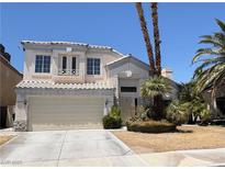 Charming two-story home features a neutral color palette, a two-car garage and desert landscaping at 3679 Funston Way, Las Vegas, NV 89129