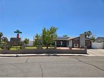 Charming single story home featuring desert landscaping, stone chimney, and solar panels at 4823 El Tesoro Ave, Las Vegas, NV 89121