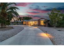 Beautiful single-story brick home with long driveway and stunning desert landscaping at 5486 Alfred Dr, Las Vegas, NV 89108