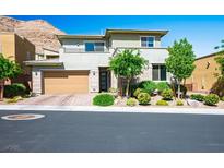 Charming two-story home featuring a well-manicured front yard, a two-car garage, and modern architectural details at 6433 Farness St, Las Vegas, NV 89135