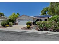 Charming single-story home featuring desert landscaping, a two-car garage, and solar panels for energy efficiency at 7100 Carrondale Way, Las Vegas, NV 89128