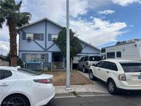 Charming two-story home with a light-blue exterior and well-maintained front yard and several parked cars at 7105 Pinelake Rd, Las Vegas, NV 89145