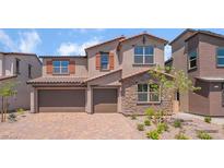 Beautiful two-story home with a two-car garage, stone accents, and a well-manicured front yard at 769 Cloud Creek St, Henderson, NV 89011