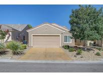 Charming single-story home with a two-car garage, desert landscaping, and a well-maintained front yard at 7916 Lyrebird Dr, North Las Vegas, NV 89084