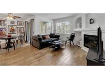 Inviting living room featuring a fireplace, comfortable seating, and ample natural light from the window at 7950 W Flamingo Rd # 1042, Las Vegas, NV 89147