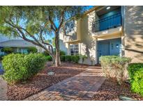 Inviting two-story townhome with a charming balcony and well-manicured landscaping at 882 Tam O Shanter, Las Vegas, NV 89109