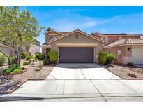 Charming two-story home with a well-maintained front yard and a spacious two-car garage at 1228 Swanbrooke Dr, Las Vegas, NV 89144