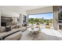 Bright living room featuring modern furnishings and expansive views of the golf course at 1429 Iron Hills Ln, Las Vegas, NV 89134