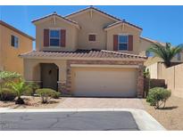 Charming two-story home with a tile roof and well-manicured landscaping showcasing curb appeal at 145 Forest Crossing Ct, Las Vegas, NV 89148