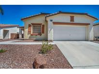 Charming single-story home with a well-manicured desert rock front yard and an attached two-car garage at 1604 Lazy Hill Ranch Way, North Las Vegas, NV 89081