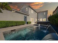 A luxurious backyard pool features a spa and a stunning waterfall, perfect for relaxation and entertainment at 2722 Marchetti Pl, Henderson, NV 89044