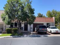 Charming single-story home with a red-tiled roof and well-maintained front yard and a two car garage at 3447 One Nation Ave, Las Vegas, NV 89121