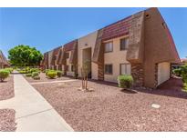 An attractive multi-Gathering residential exterior featuring a stone facade and well-maintained landscaping at 5301 River Glen Dr # 205, Las Vegas, NV 89103