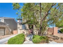Charming two-story home featuring a well-manicured front yard with mature landscaping at 582 Brompton St, Las Vegas, NV 89178