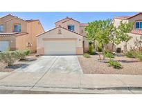 Charming single-Gathering home featuring a well-maintained front yard and attached two-car garage at 700 Red Bark Ln, Henderson, NV 89011