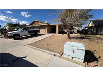 Modest single-story home with attached garage and desert landscaping at 7056 Sprucewood St, Las Vegas, NV 89147