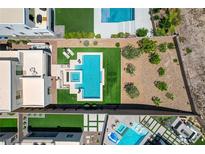 Stunning aerial view of backyard oasis with pool, spa, and modern outdoor furniture at 734 Glowing Horizon St, Henderson, NV 89052