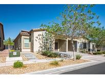 Charming single-story home featuring a desert-landscaped front yard with a covered entryway at 7472 Brody Meadows St, North Las Vegas, NV 89084