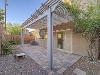 A covered back patio features brick pavers, desert landscaping, and access to the home's interior at 7605 Lake Fork Peak St, Las Vegas, NV 89166