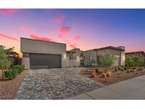 Stunning modern home with a beautiful brick driveway and desert landscaping at 818 Calluna St, Las Vegas, NV 89138