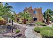 Condo exterior with palm trees, landscaping, and a walkway leading to the building entrance at 900 Heavenly Hills Ct # 114, Las Vegas, NV 89145