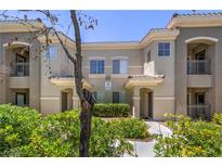 Charming condo building featuring stucco facade, tile roof, manicured landscaping, and private balconies at 9050 W Warm Springs Rd # 2062, Las Vegas, NV 89148