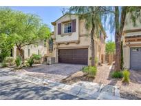 Two-story home with a brick-paved driveway and attached two-car garage at 9814 Gifthouse St, Las Vegas, NV 89178