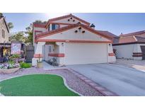 Charming home featuring stucco siding, a red tile roof, two-car garage, and xeriscaped yard at 117 Lotus Blossom Ct, Las Vegas, NV 89145