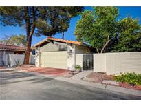 Charming single-story home featuring a two-car garage, gated entry, and brick-paved driveway at 1905 Plaza Del Padre, Las Vegas, NV 89102