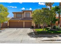 Charming two-story home featuring a well-maintained lawn, mature trees, and a spacious two-car garage at 2042 Maple Springs St, Henderson, NV 89002