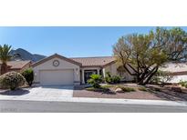 Charming single-story home featuring a well-manicured front yard and attached two-car garage at 2755 Darby Falls Dr, Las Vegas, NV 89134