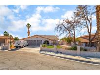 Charming single-story home showcasing a well-maintained front yard, two car garage, and inviting curb appeal at 327 Fuente Dr, Henderson, NV 89014