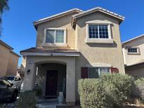 Charming two-story home featuring well-maintained landscaping and a welcoming covered front porch at 5656 Fast Payout Ct, Las Vegas, NV 89122